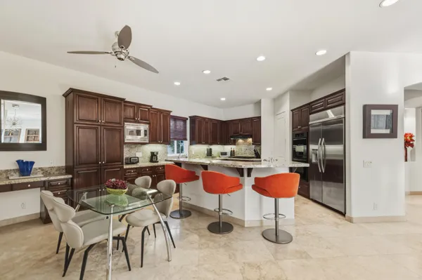 a kitchen with stainless steel appliances granite countertop a refrigerator and a sink