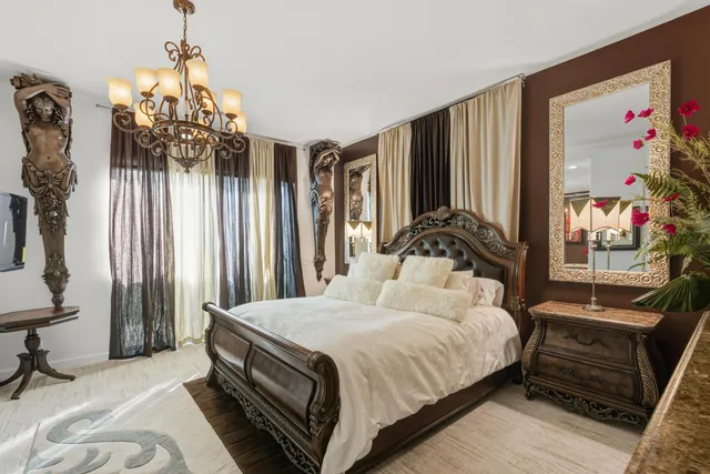 a bedroom with a bed and a chandelier