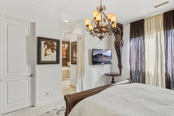 a living room with a table chairs and a chandelier