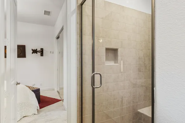 a bedroom with two bed and a window