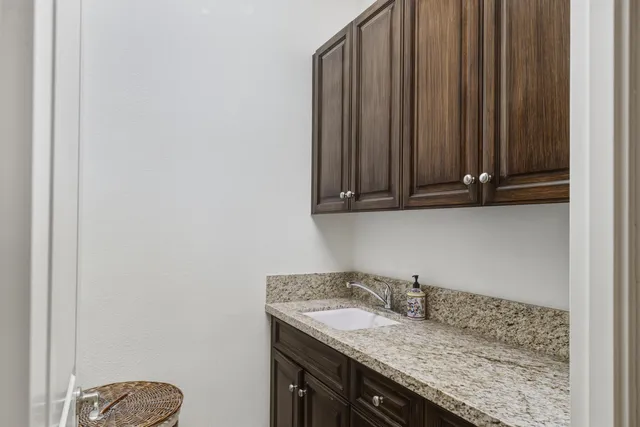 a view of a house with palm trees and a small yard
