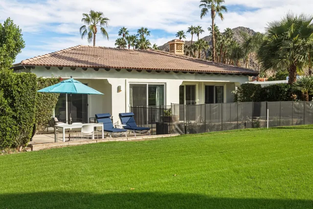 a view of a golf course with the ocean