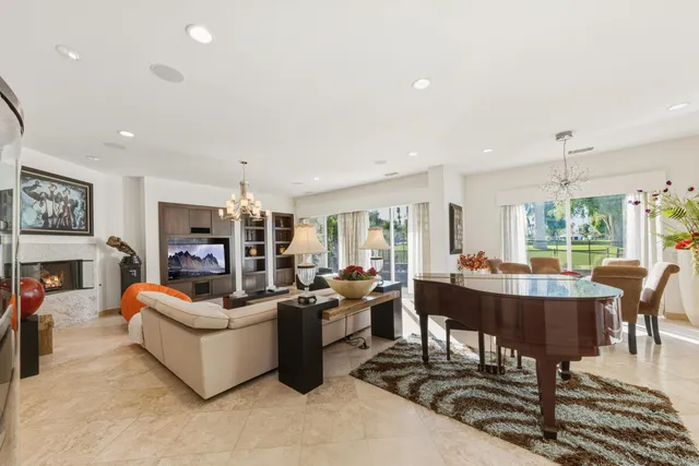 a living room with furniture a rug and a chandelier