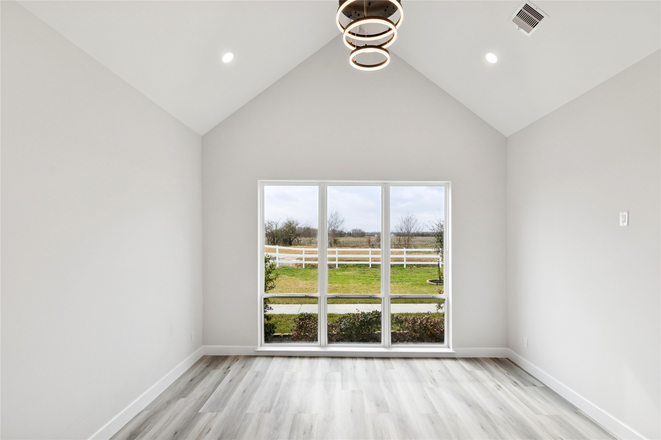 5766 Ward Bend Road Sealy, TX 77474 - Photo 28 of 45 an empty room with wooden floor and windows