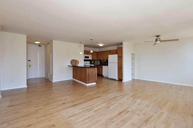 655 West Irving Park Road, Unit 312 Chicago, IL 60613 - Photo 5 of 10 a view of empty room with wooden floor