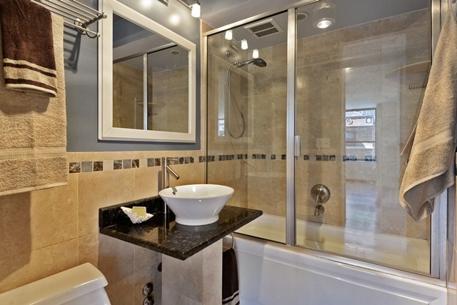 655 West Irving Park Road, Unit 312 Chicago, IL 60613 - Photo 8 of 10 a bathroom with a sink and a mirror