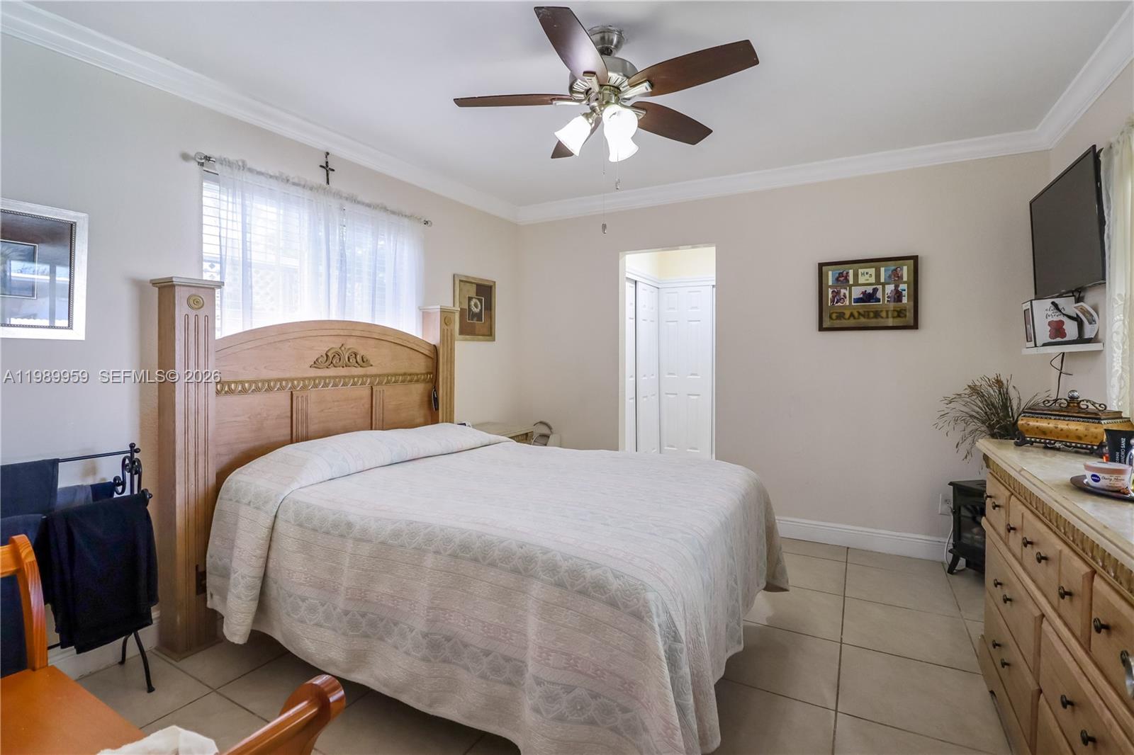 10941 Southwest 180th Street Miami, FL 33157 - Photo 13 of 29 a bedroom with a bed and a flat screen tv