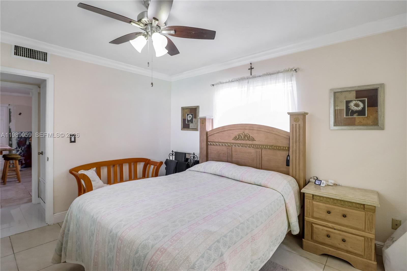 10941 Southwest 180th Street Miami, FL 33157 - Photo 14 of 29 a bedroom with a bed and a chandelier