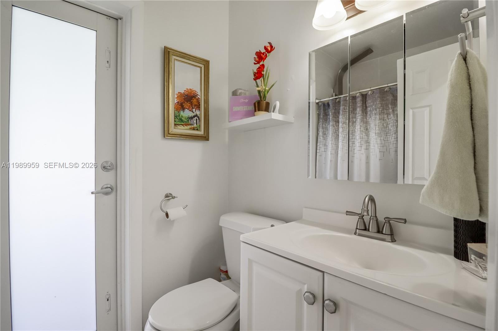 10941 Southwest 180th Street Miami, FL 33157 - Photo 15 of 29 a bathroom with a sink toilet and vanity