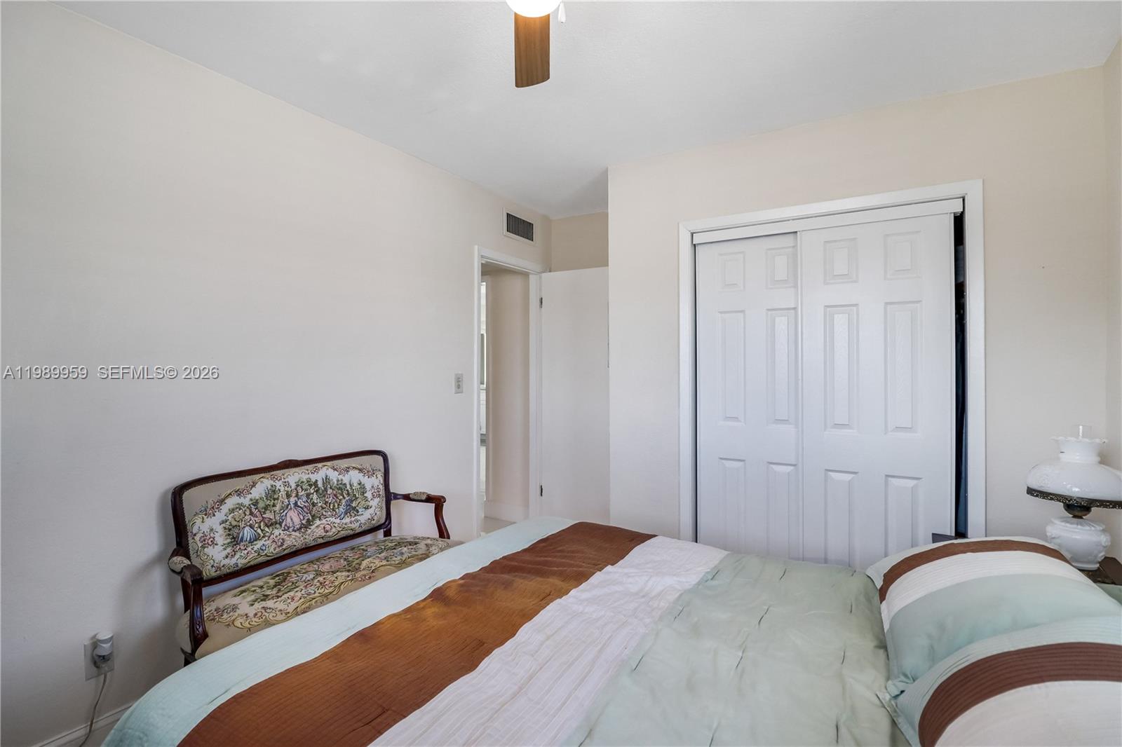 10941 Southwest 180th Street Miami, FL 33157 - Photo 17 of 29 a bedroom with a bed and a painting on the wall