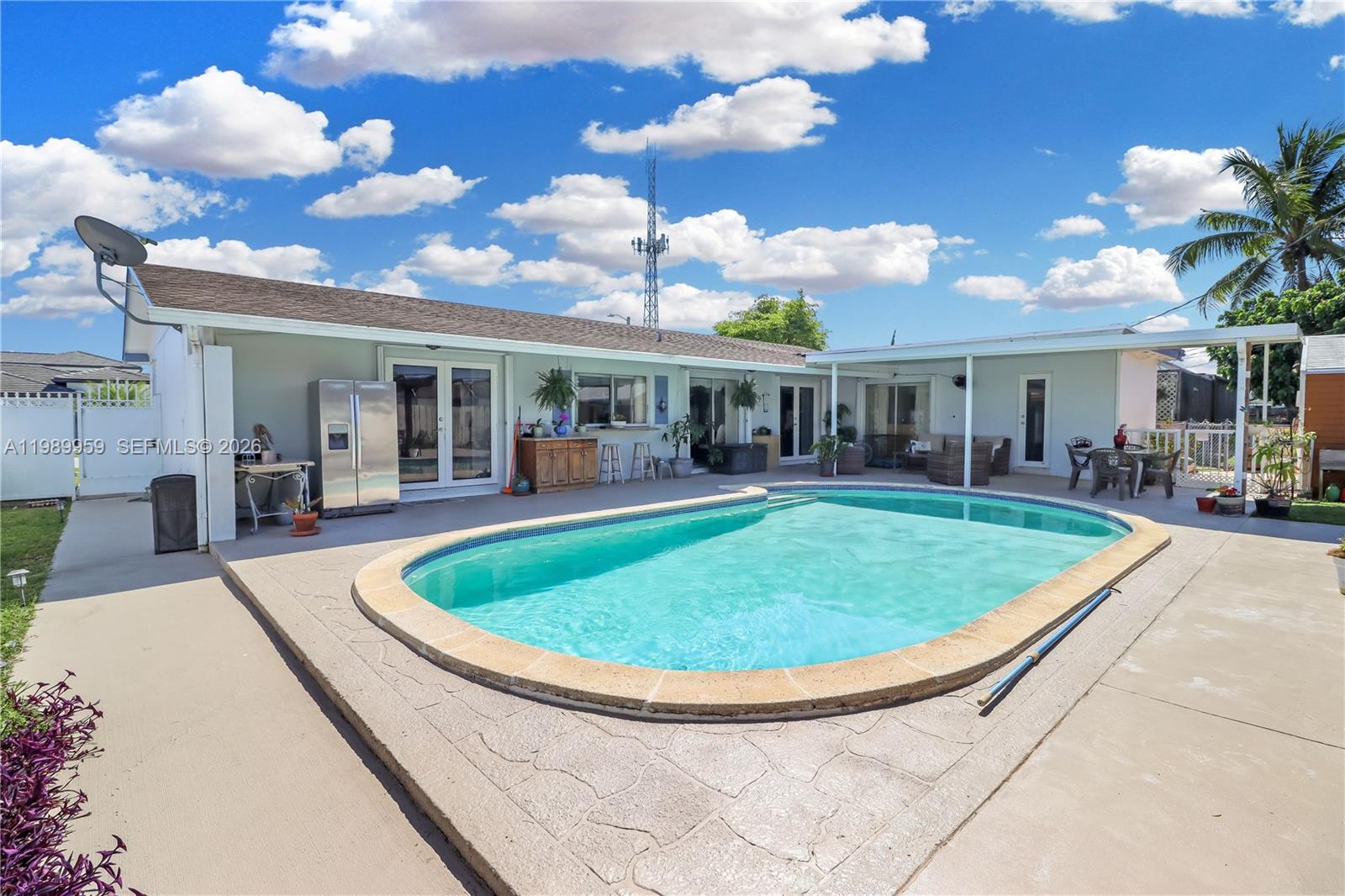 10941 Southwest 180th Street Miami, FL 33157 - Photo 2 of 29 a view of a house with swimming pool and porch