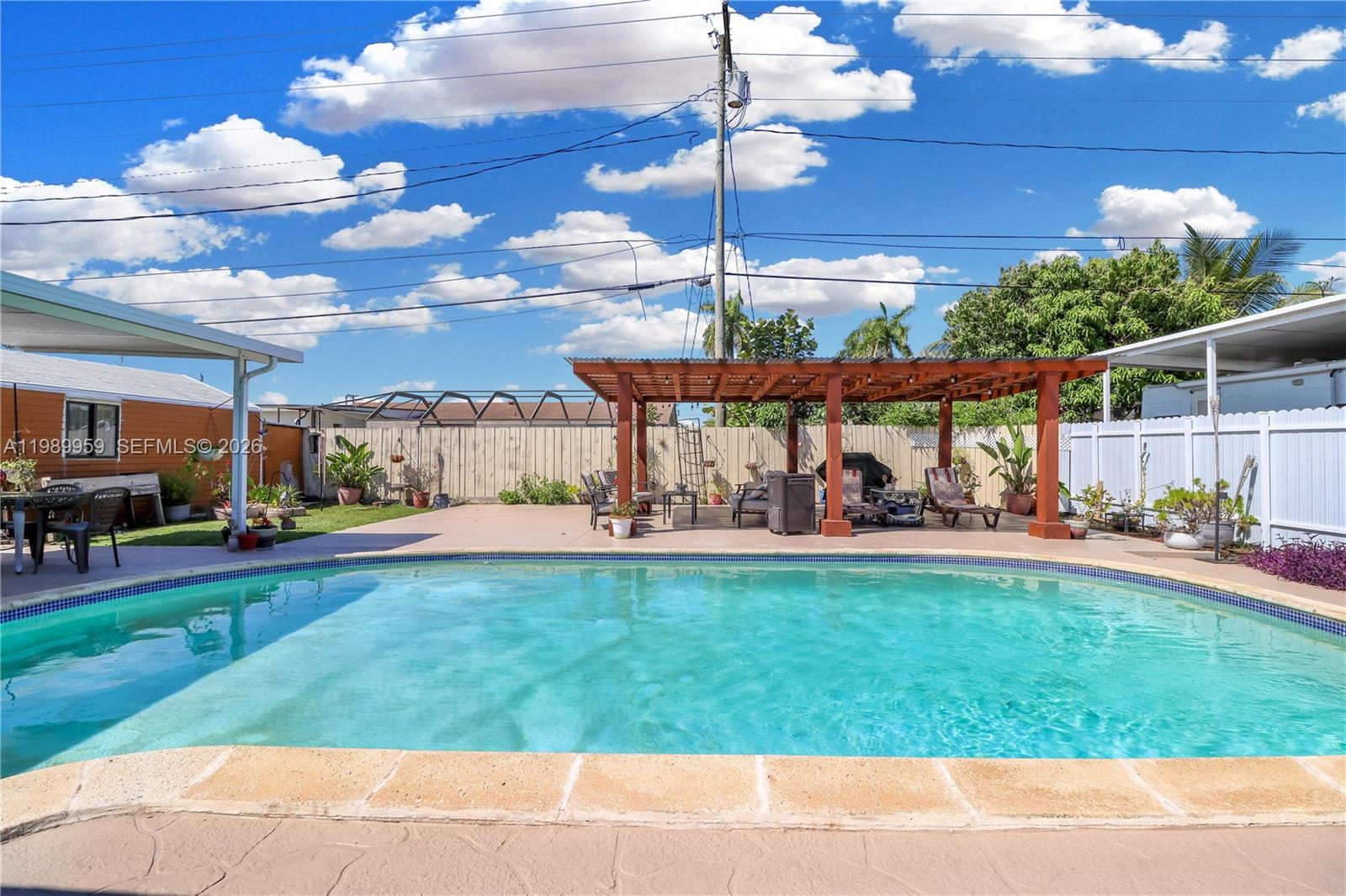 10941 Southwest 180th Street Miami, FL 33157 - Photo 23 of 29 a view of a swimming pool and outdoor seating