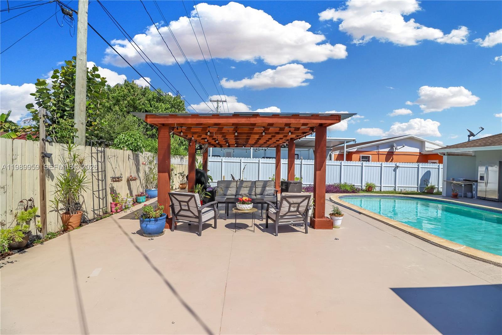 10941 Southwest 180th Street Miami, FL 33157 - Photo 25 of 29 a view of a patio with a table and chairs