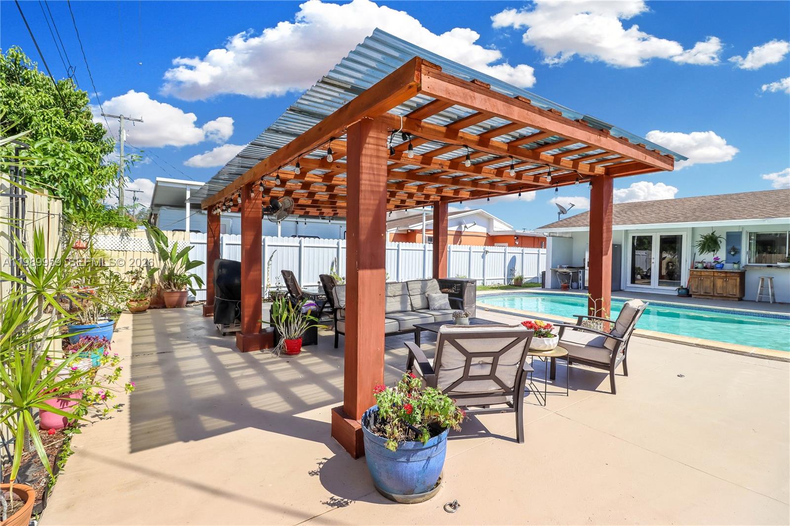 10941 Southwest 180th Street Miami, FL 33157 - Photo 27 of 29 a patio with yard glass top table and chairs