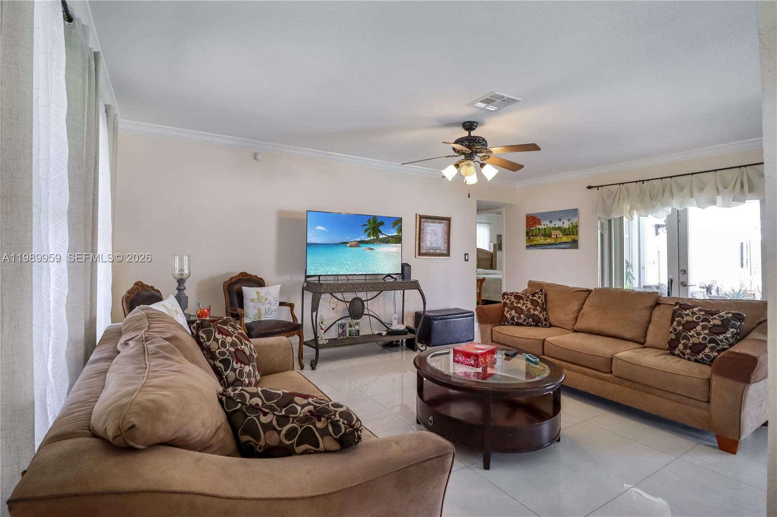 10941 Southwest 180th Street Miami, FL 33157 - Photo 4 of 29 a living room with furniture and a chandelier
