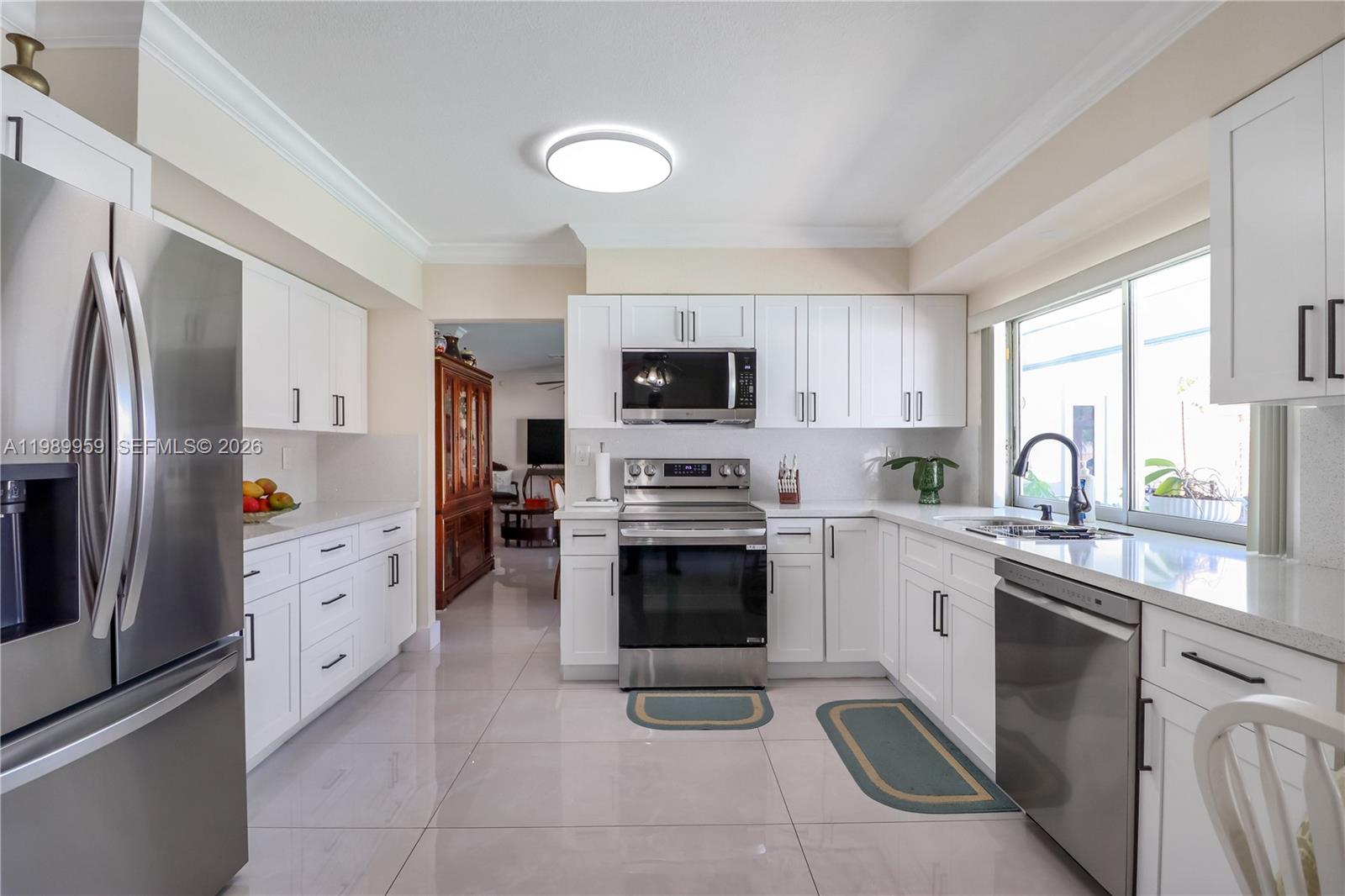 10941 Southwest 180th Street Miami, FL 33157 - Photo 8 of 29 a kitchen with cabinets stainless steel appliances and a window