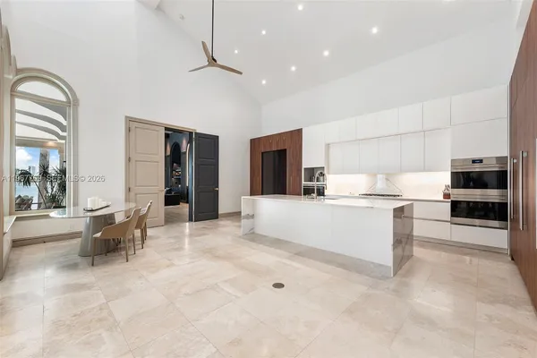 a large white kitchen with cabinets and stainless steel appliances
