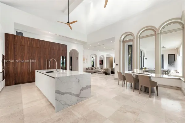 a large kitchen with stainless steel appliances granite countertop a lot of counter space and a sink