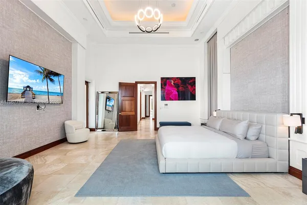 a bedroom with a bed a chair and a couch