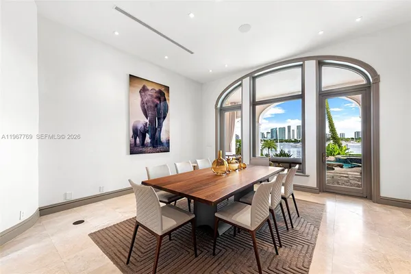 a dining room with furniture and view of kitchen