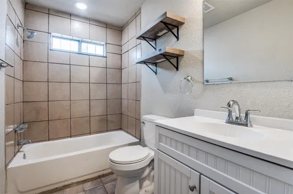 a bathroom with a sink a toilet and bathtub