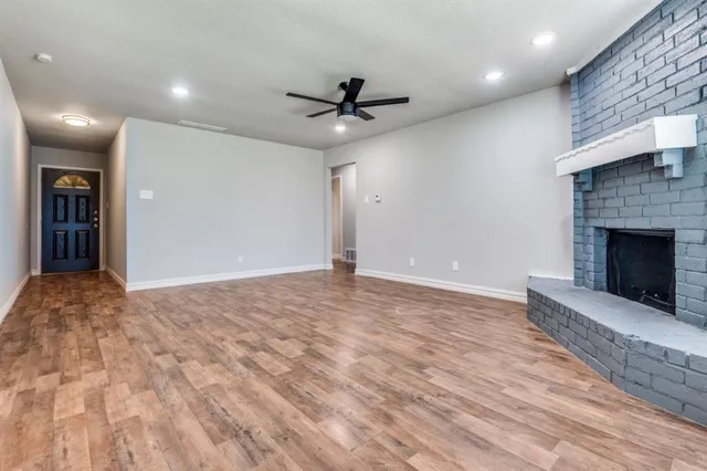 a view of an empty room with a fireplace
