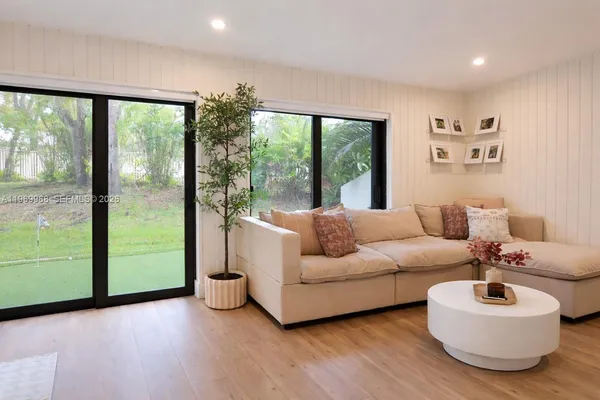 a living room with furniture and a large window
