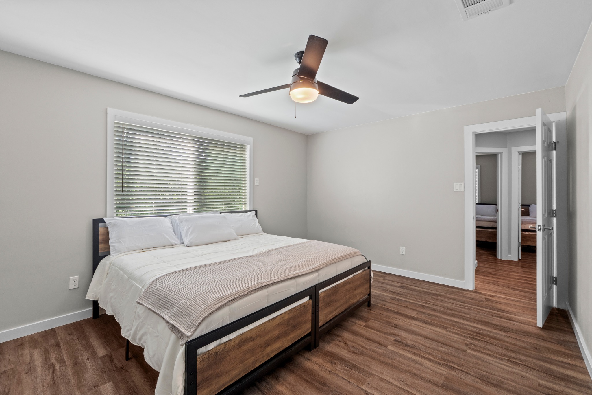 11811 Rotherham Drive Austin, TX 78754 - Photo 19 of 37 Wood flooring and a modern ceiling fan elevate the comfort of this private sleeping space.
