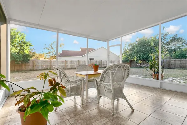 a dining room with furniture and a floor to ceiling window