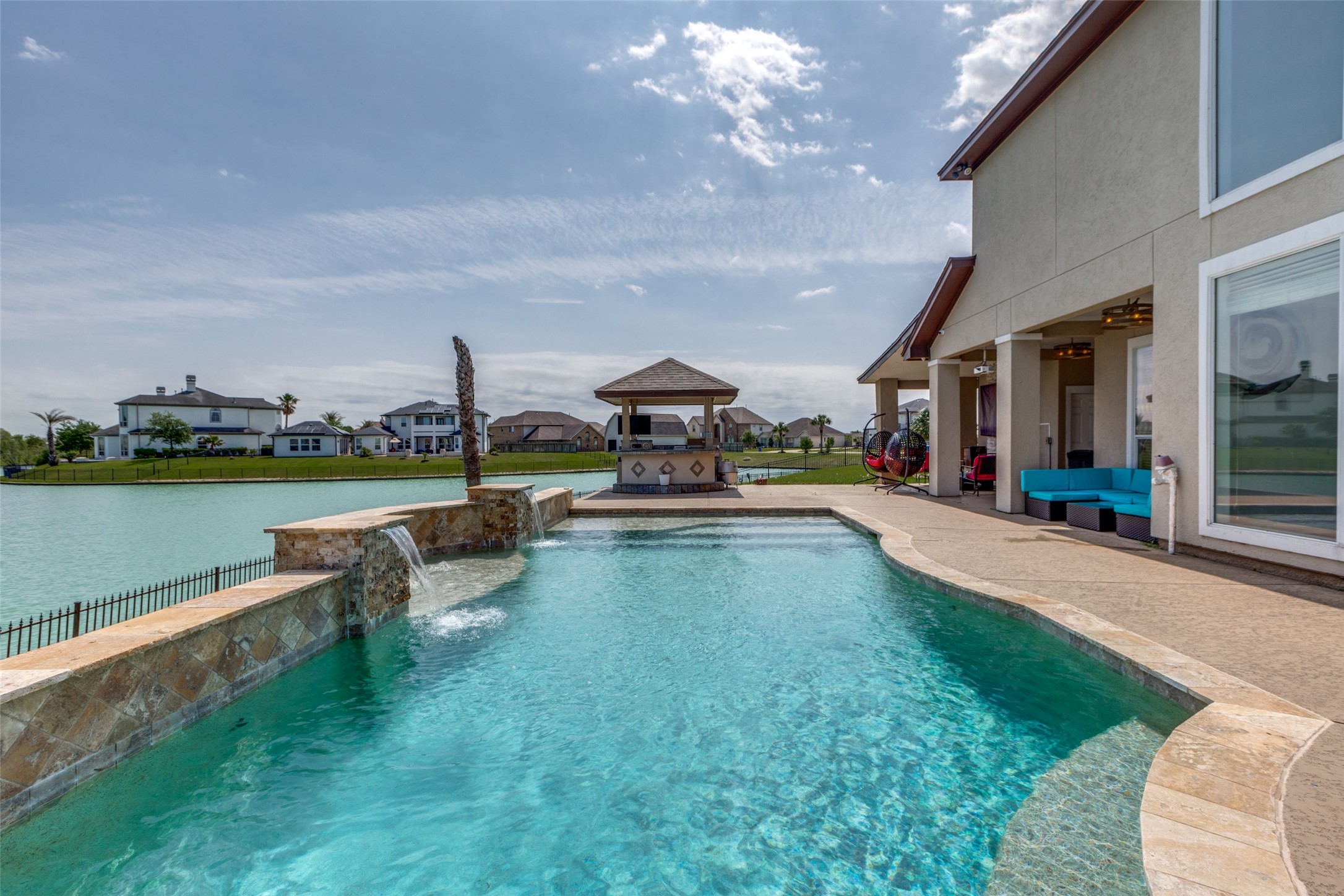 8 Cypress Point Court Manvel, TX 77578 - Photo 2 of 18 a view of a house with patio swimming pool and outdoor seating