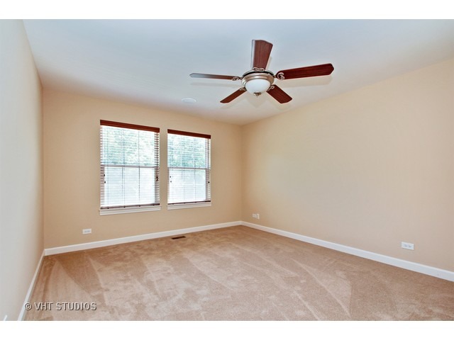 287 Hickory Road Lake Zurich, IL 60047 - Photo 17 of 25 a view of room with a ceiling fan and window