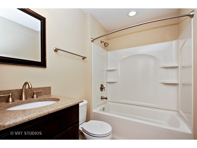 287 Hickory Road Lake Zurich, IL 60047 - Photo 22 of 25 a bathroom with a granite countertop sink toilet and shower