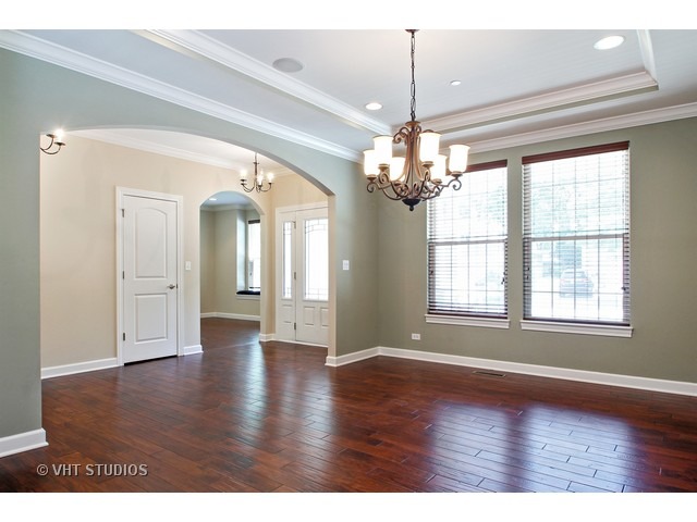 287 Hickory Road Lake Zurich, IL 60047 - Photo 5 of 25 an empty room with wooden floor and windows