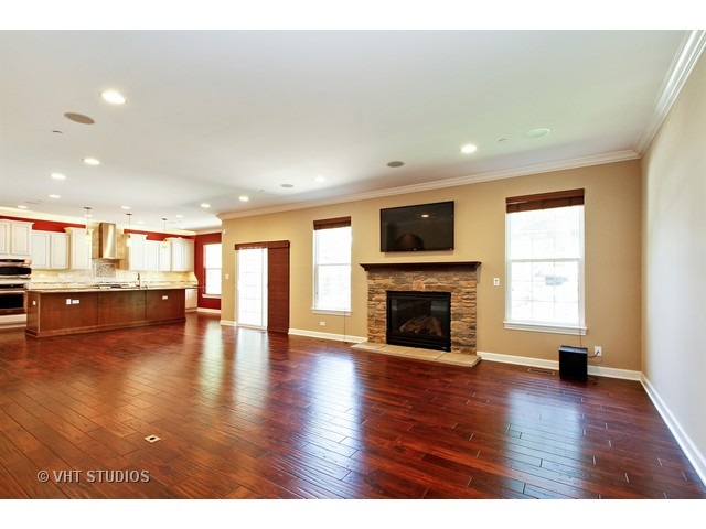 287 Hickory Road Lake Zurich, IL 60047 - Photo 6 of 25 a view of an empty room with wooden floor and a fireplace