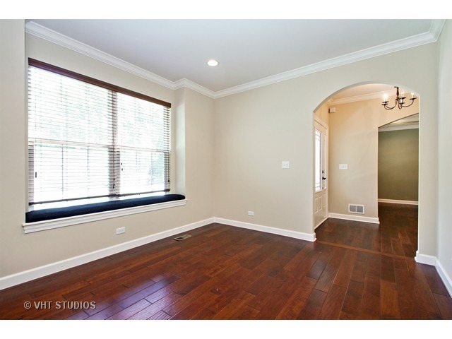 287 Hickory Road Lake Zurich, IL 60047 - Photo 7 of 25 an empty room with wooden floor and windows