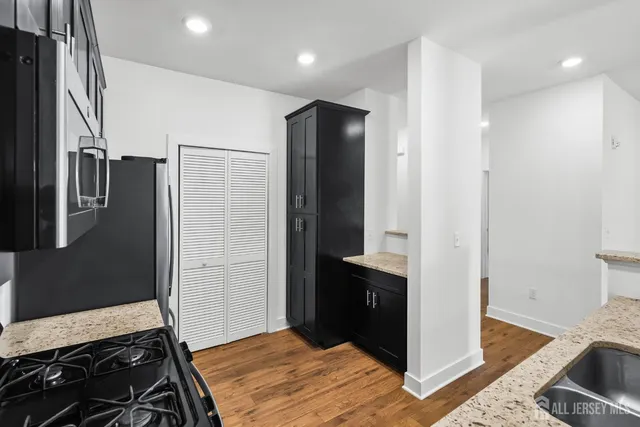 a kitchen with a refrigerator and a stove