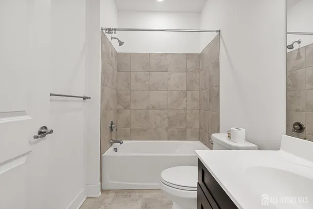 a bathroom with a sink a toilet and bathtub