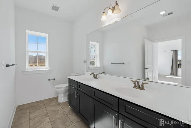 a bathroom with a shower sink and mirror