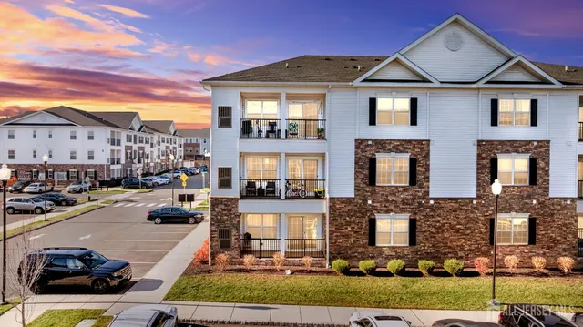 a view of a swimming pool with outdoor seating and a garden