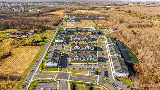 an aerial view of a residential apartment building with a yard