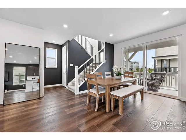 a living room with furniture wooden floor and potted plants