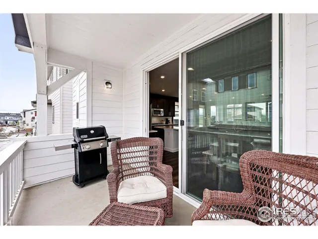 a living room with furniture a wooden floor and next to a window