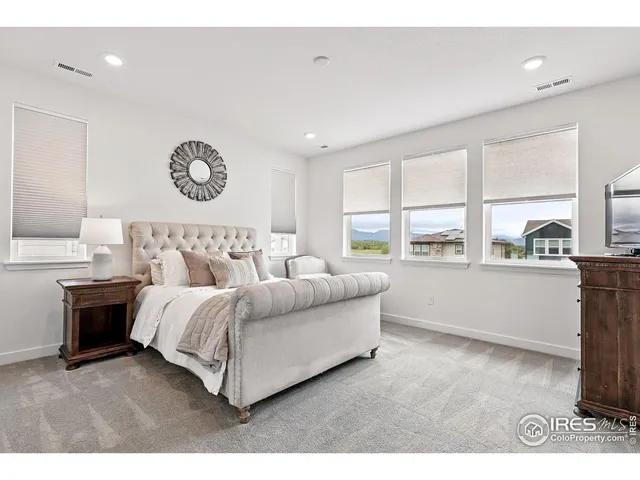 a bedroom with a bed and a large mirror