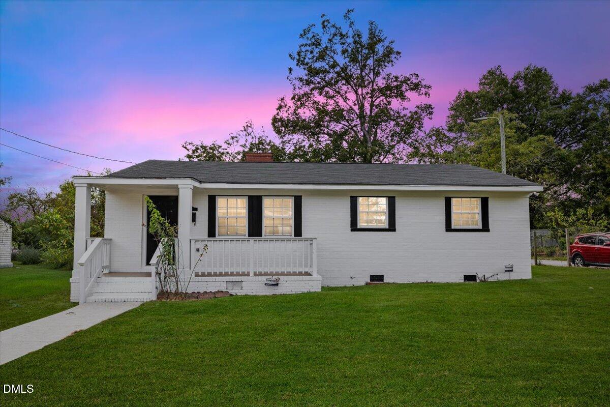 315 Hamilton Street Henderson, NC 27536 - Photo 1 of 13 a front view of a house with a garden