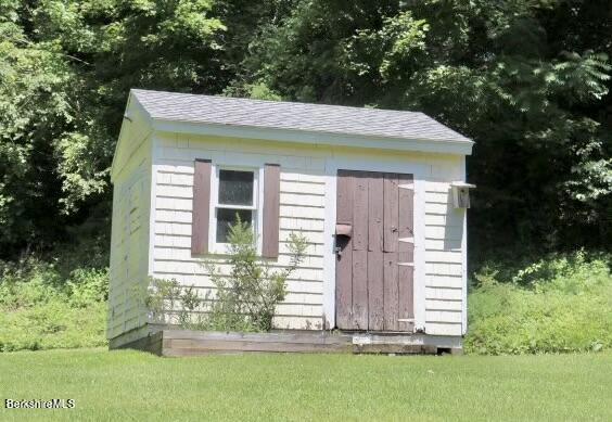 365 Water Street Lee, MA 01238 - Photo 5 of 35 a view of a wooden house with a small yard
