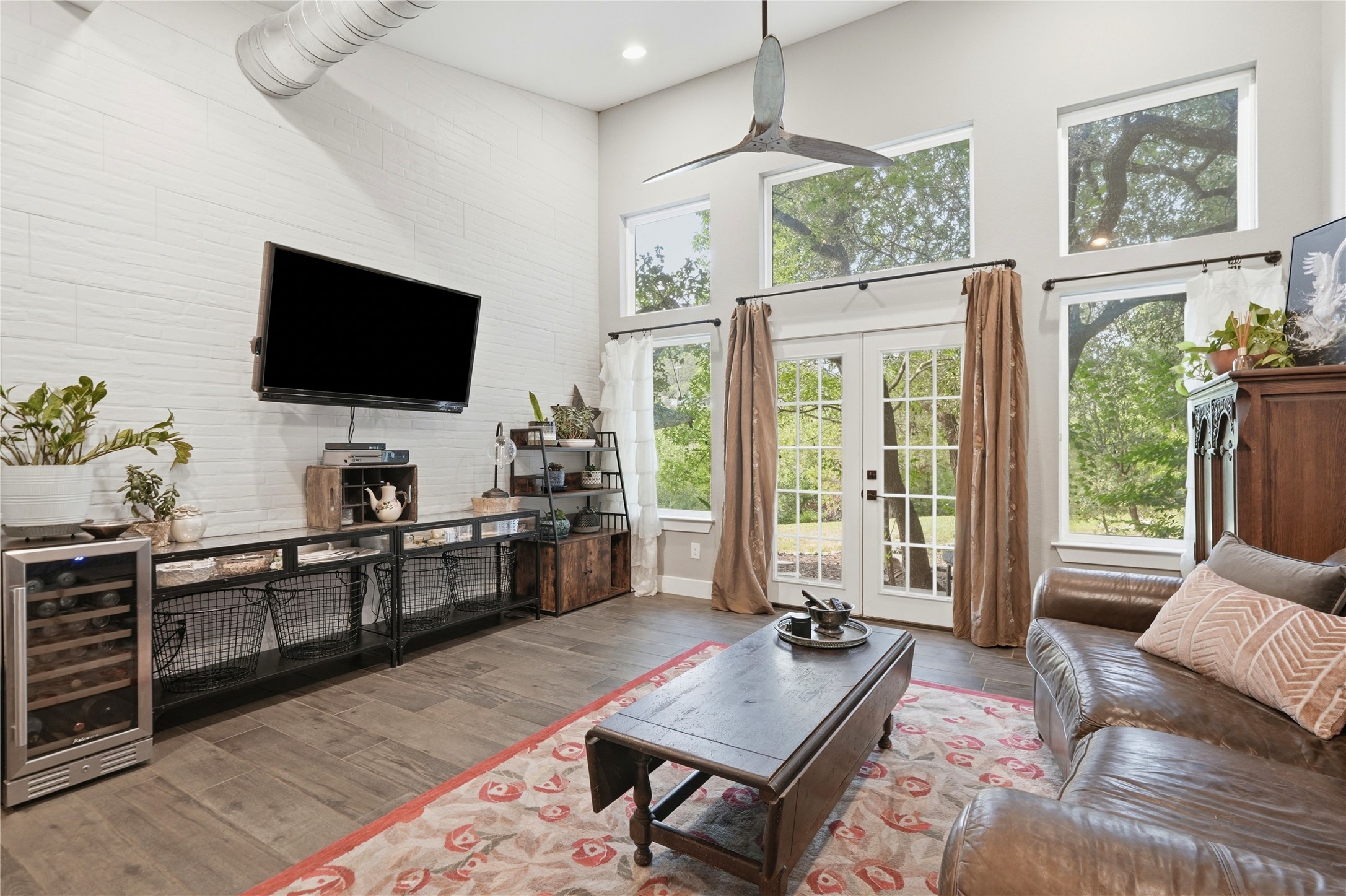 18406 Roundrock Road Jonestown, TX 78645 - Photo 25 of 33 a living room with furniture a flat screen tv and a large window
