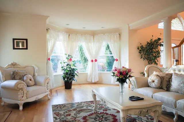 a living room with furniture a fireplace and a large window