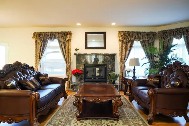 a view of a dining room with furniture a chandelier and wooden floor