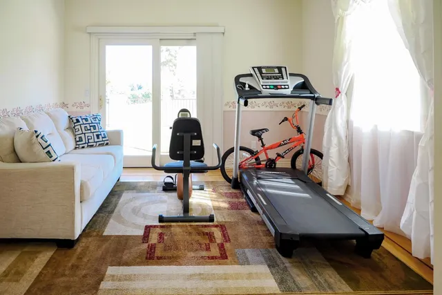 a view of a hallway with wooden floor and a potted plant