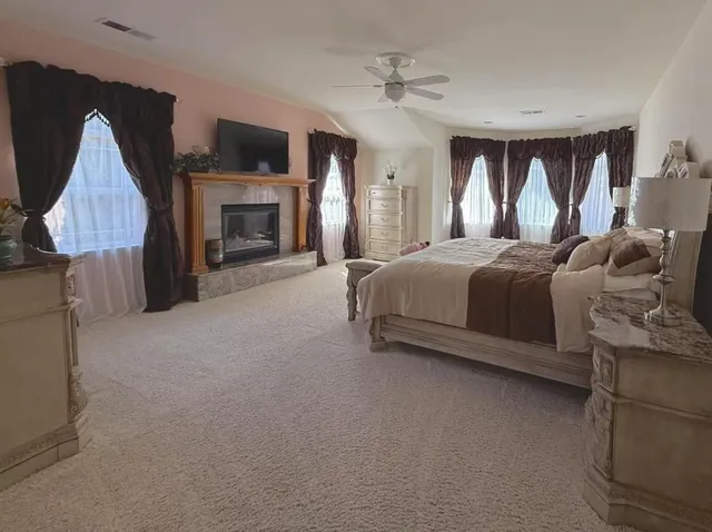 a bedroom with a bed and a bathroom with a sink